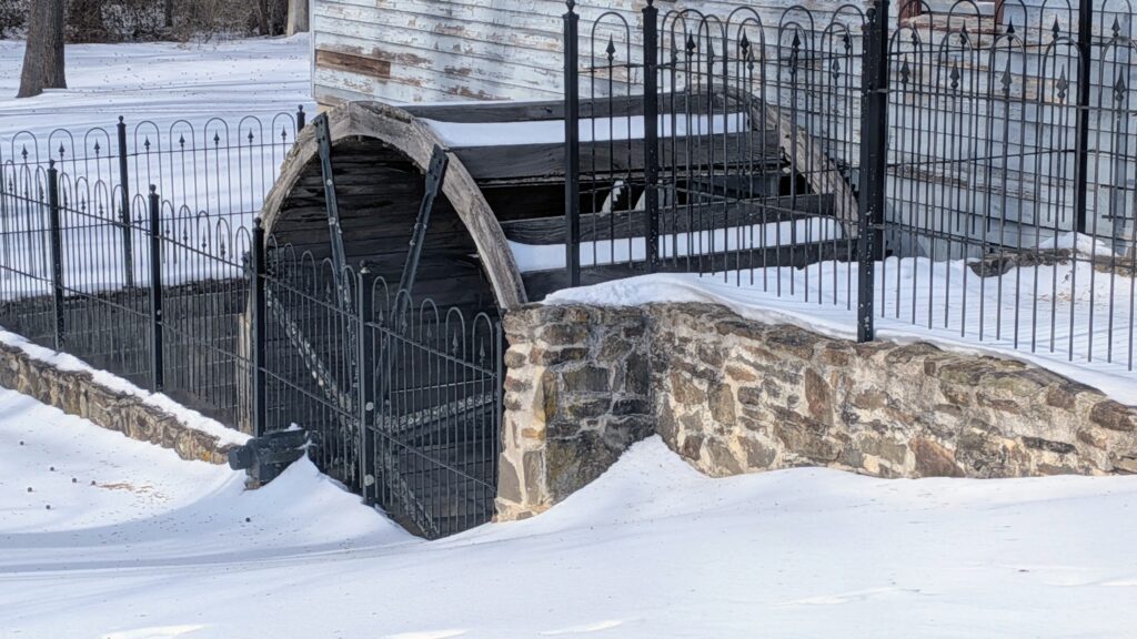 A reproduction of the old water wheel used to turn the grist stones
