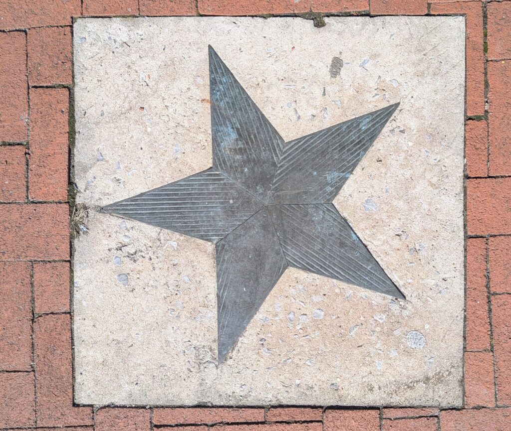 The star embedded in concrete surrounded by brick on Star Corner in Salem City