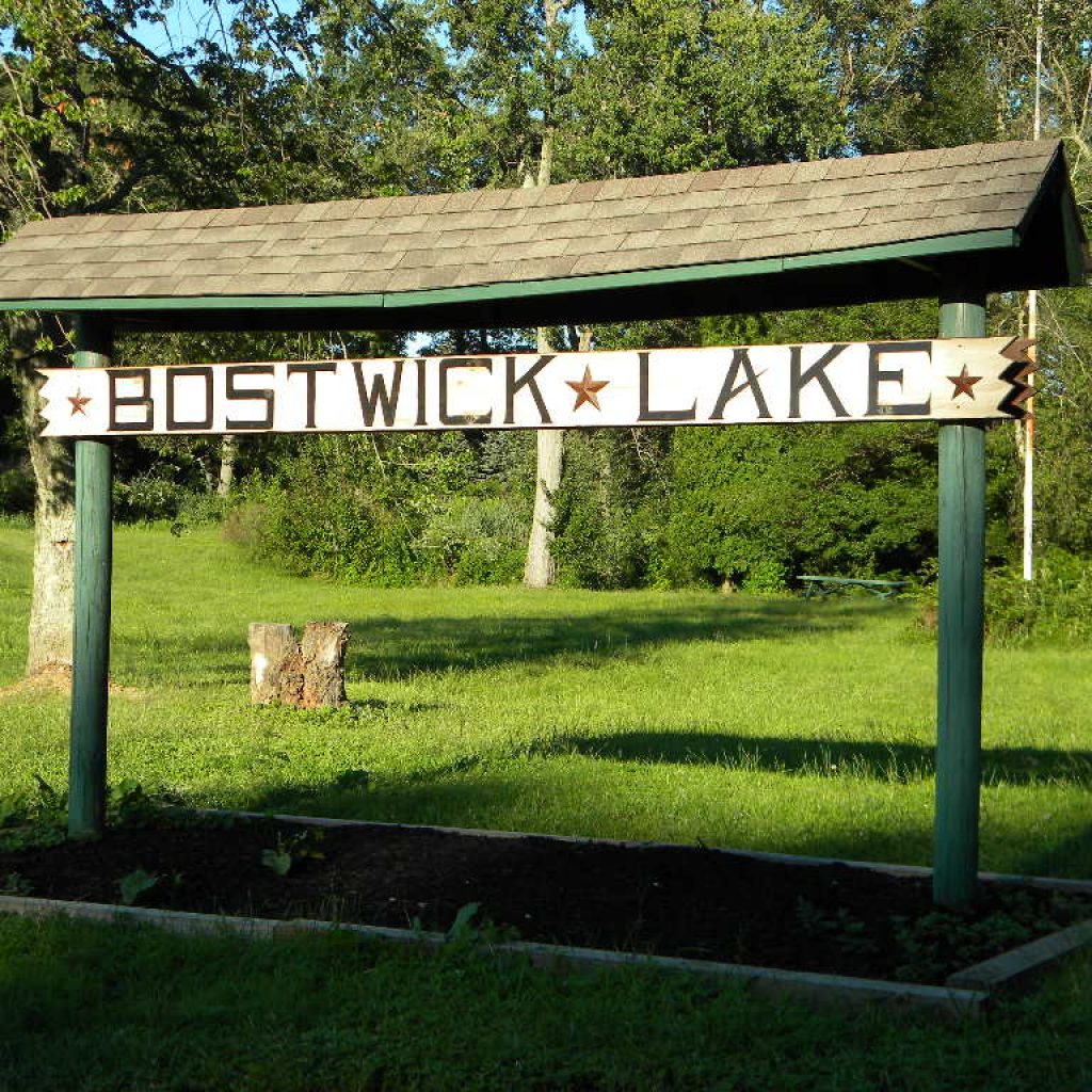 Bostwick Lake sign next to the public parking lot along Friesburg Road.