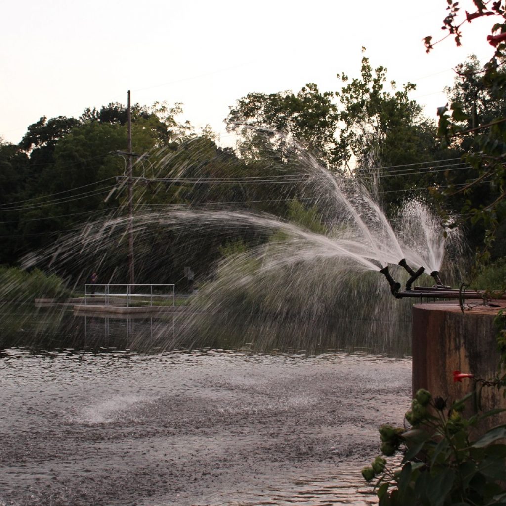 The water from the water pump station being pumped back into the lake.