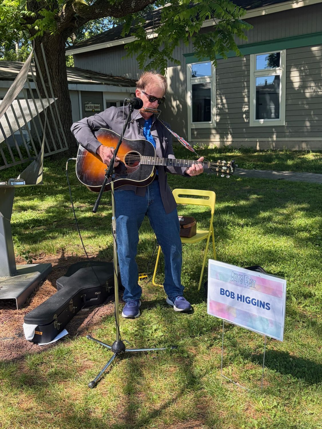Bob Higgins playing his harmonica and guitar