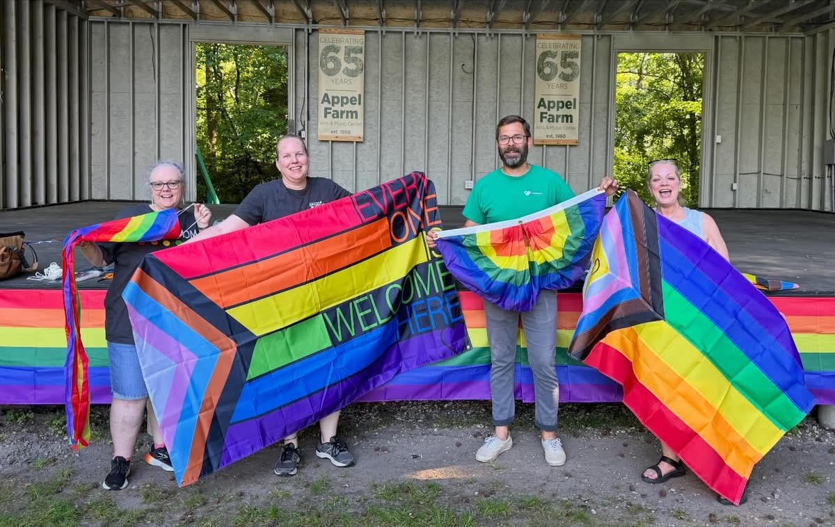 Members of Salem County Pride holding up flags during the event