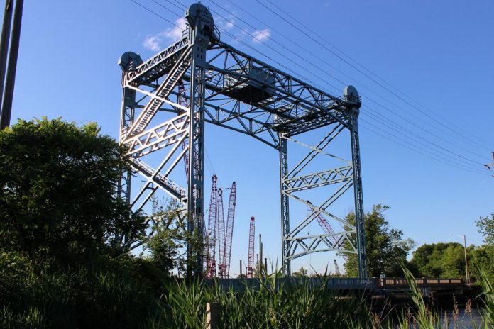 View from the side afar of the Nortonville Bridge Historic Truss Bridge in Oldmans Township