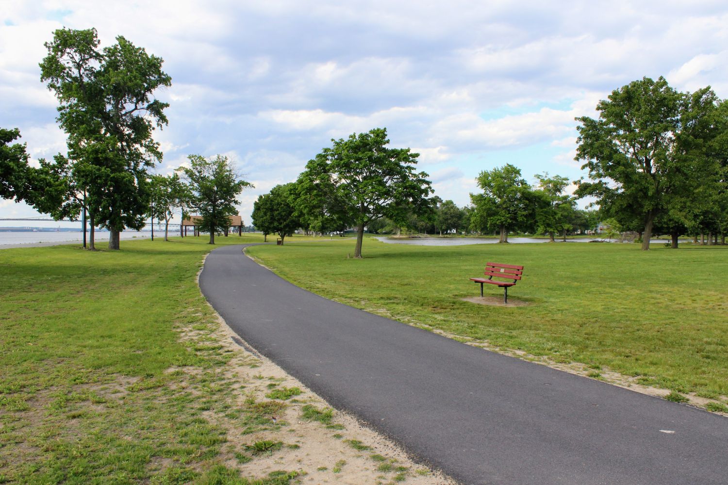 Walking Path at Riverview Beach Park with empty Bench