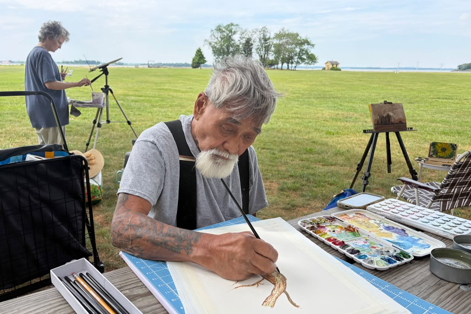 Michael Ohno working on his painting