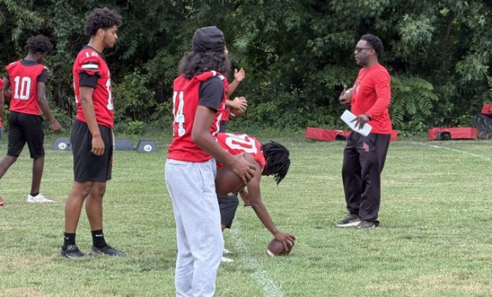 New Penns Grove football coach Damian Ware lines up his offense during the early days of training camp.