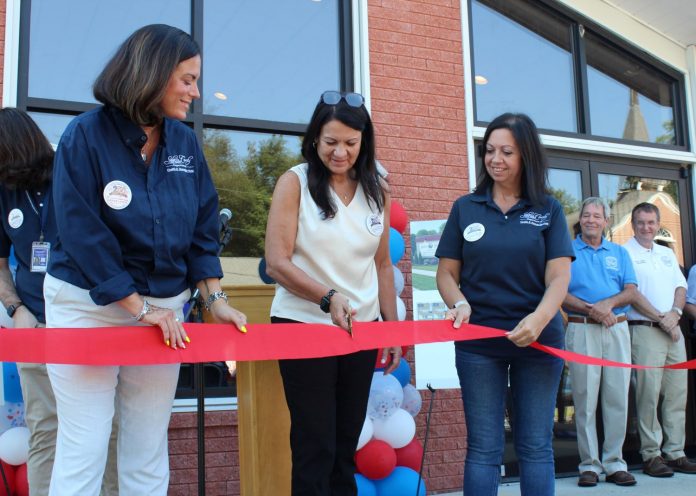 Salem County Department of Health and Human Services June Seiber along with members of her staff holding the ribbon