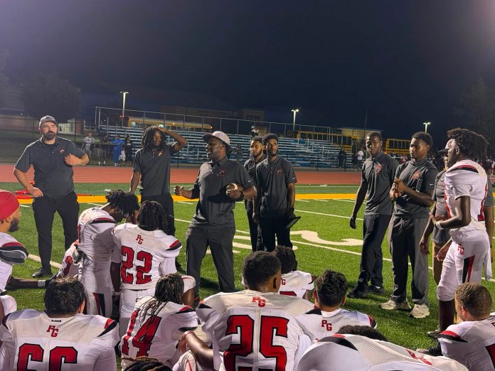 Coach Damian Ware addresses team at halftime