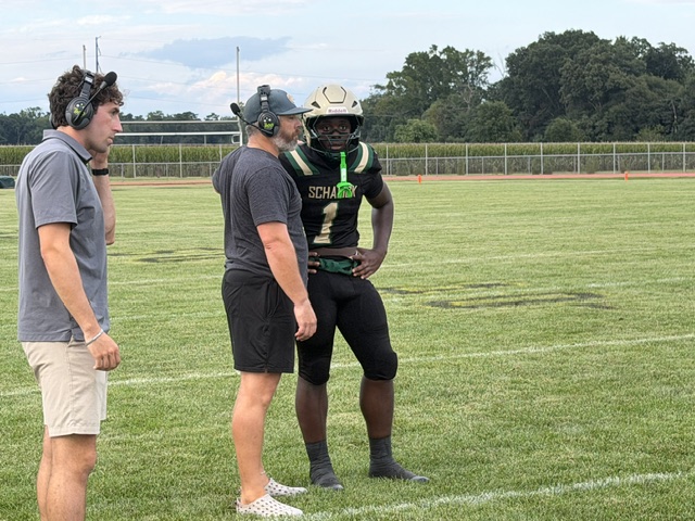 Schalick quarterback Kenny Bartee (1) gets a play from head coach Kevin Leamy.