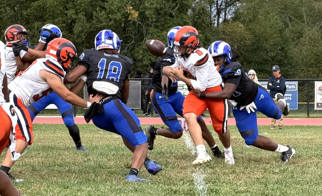 Salem defensive lineman Raymond Brown wraps up Overbrook quarterback Mark Hailstork and forces a fumble on his first play of the season.