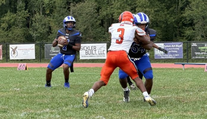 IMG_2893 Salem quarterback Desmund Thomas throws a touchdown pass on his first official play of the season. (Photo credits: Lucky Shot Pix)