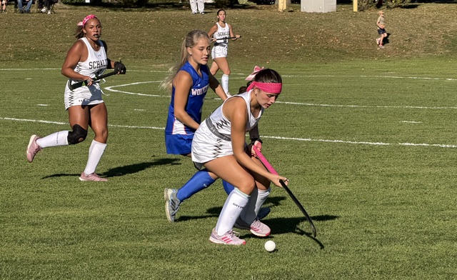Schalick's Genevieve Smith (R) tries to turn the ball away from Woodstown's Margaux Lipovsky during Tuesday's field hockey game.