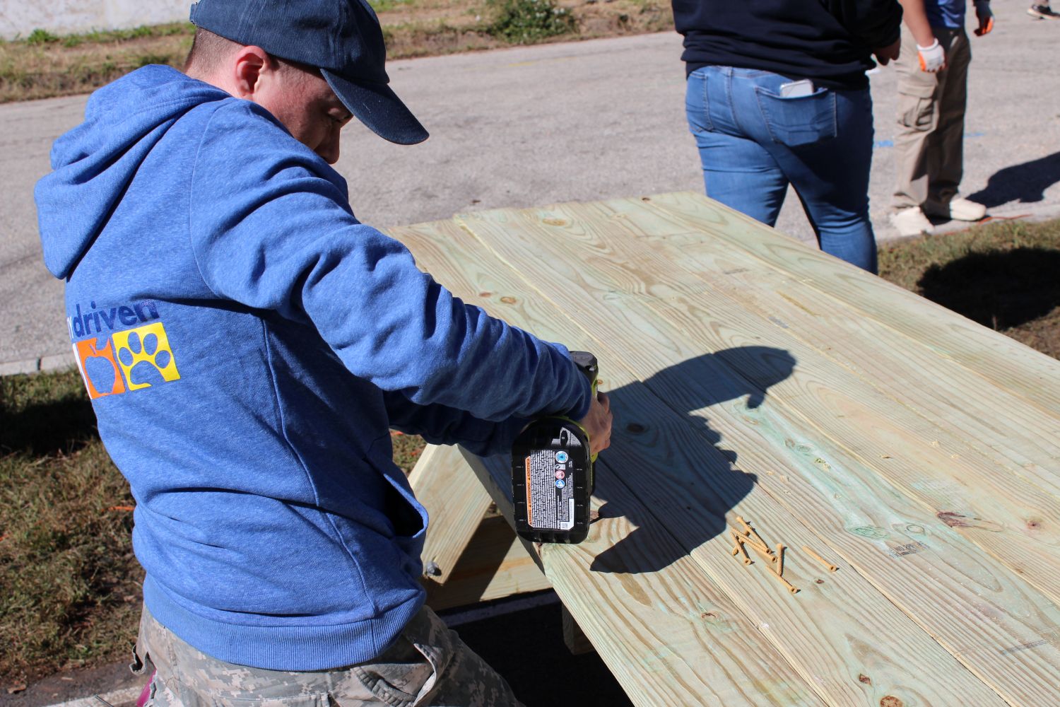 Volunteer nailing down the last board.